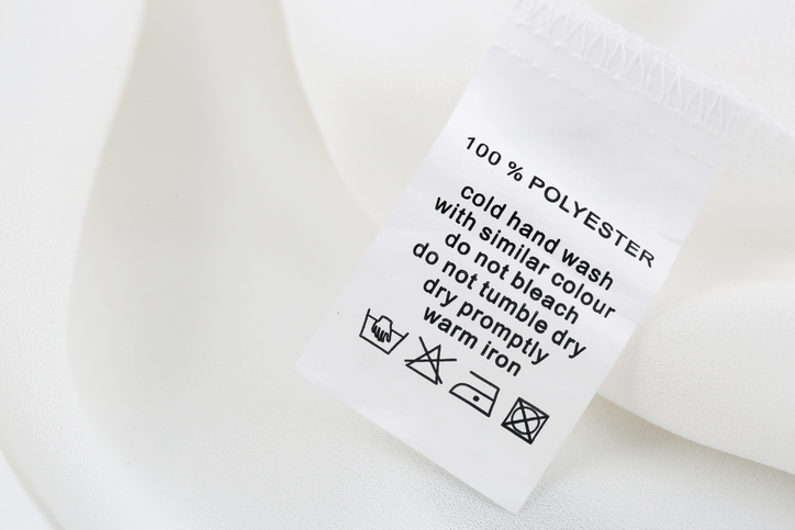 Fabric composition and washing instructions label on white garment