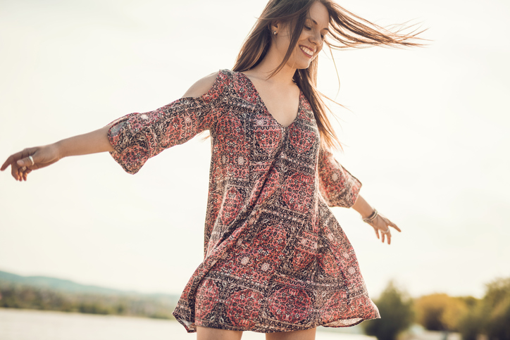 Carefree young woman spinning outdoors and having fun.