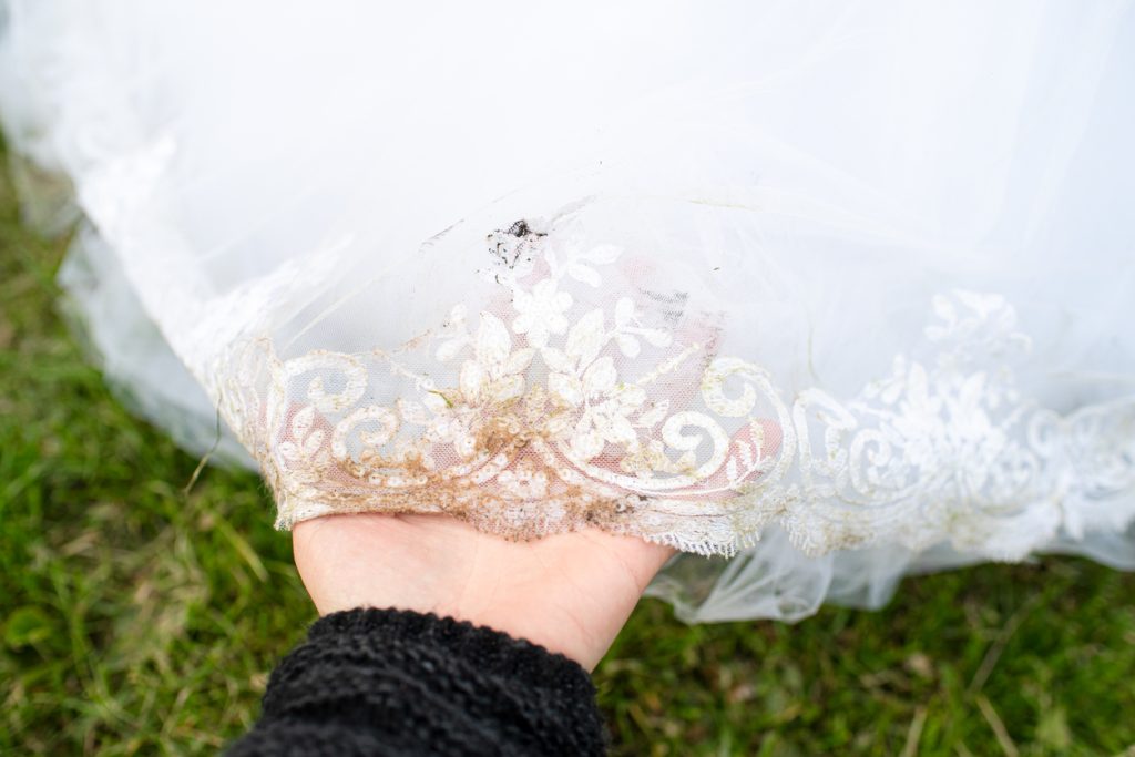 Bridal white dress has lost its look. Dirty wedding dress with stains. Theme of dry cleaning and laundry services